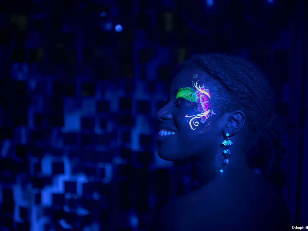Maquillage fluorescent réalisé sur une invitée lors d'une soirée